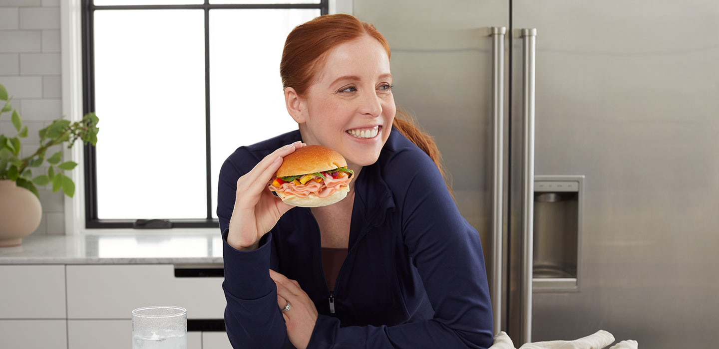 woman eating turkey sandwhich